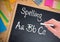 Hand writing Spelling text on blackboard