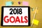 Hand writing text caption inspiration showing 2018 Goals. Business concept for financial planning, business strategy Written on ta