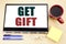 Hand writing text caption inspiration showing Get Gift. Business concept for Free Shoping Coupon written on tablet laptop. Office