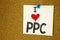 Hand writing text caption inspiration showing I Love PPC - Pay per Click concept meaning Internet SEO Money Loving written on stic