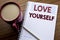 Hand writing text caption inspiration showing Love Yourself. Business concept for Positive Slogan For You written on note paper no