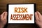 Hand writing text caption Risk Assessment. Business concept for Safety Danger Analyze Written on tablet laptop, wooden background