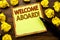 Hand writing text caption showing Welcome Aboard. Business concept for Greeting Join Member Written on sticky note paper, wooden b