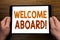 Hand writing text caption Welcome Aboard. Business concept for Greeting Join Member Written on tablet laptop, wooden background wi