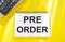 Hand writing the text: Pre-Order, business concep, yellow background