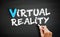 Hand writing Virtual Reality on blackboard, concept background