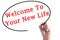 Hand writing Welcome To Your New Life on transparent board