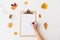 Hand writing on white paper on clipboard in autumn