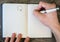 Hand writing white pen notebook with diamond ring