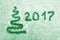 Hand written 2017 and abstract xmas tree on snow. New year and Christmas card in green.