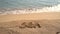 Hand written text sea on the beach. slow motion