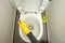 Hand in yellow gloves toilet wash