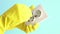 Hand in yellow rubber gloves using screwdriver tool screwing electric socket outlet repair close up