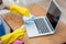 Hand of young asian woman cleaning and wipe laptop computer with disinfect and alcohol for protect pandemic.