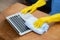 Hand of young asian woman cleaning and wipe laptop computer with disinfect and alcohol for protect pandemic covid-19.