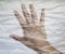 Hand of a young female wrapped in plastic film showing different symbols