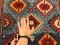 Hand of a young girl on the carpet with Oriental patterns. From the beauty next series