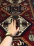 Hand of a young girl on the carpet with Oriental patterns. From the beauty next series