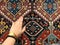 Hand of a young girl on the carpet with Oriental patterns. From the beauty next series