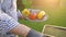 Hand of young man grilling vegetables on the barbecue plate with glowing coals, summer picnic time, bbq grill with fire