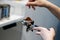 The hand of a young man is operating a professional coffee machine, focus select point