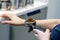 The hand of a young man is operating a professional coffee machine, focus select point