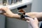 The hand of a young man is operating a professional coffee machine, focus select point