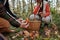 Hand of young unrecognizable male backpacker holding fresh boletus