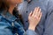 Hand of young woman with wedding ring on the chest of man in plaid shirt. Ð¡ouple in love. Man and woman are standing embracing.