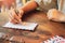 Hand young  woman writing the send a paper letter through the post office with nostalgia and concern family on wooden table with