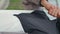 Hand zipping sport jacket street vertical closeup. Fitness man cardio training