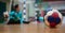 Handball ball on court floor. Blurred female goalkeeper background. Space for text, close up view.