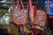 Handcrafted Indian traditional handbags displayed outside street shop.