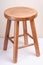 Handcrafted wooden backless stool on white background isolated