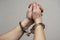 Handcuff on mans arms, praying for forgiveness. Chained hands praying. Praying inmate