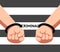 Handcuffed hands of prisoner and chain shaped like word 