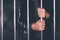 Handcuffed man behind prison bars