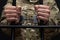 A handcuffed soldier behind the bars against a black background. Concept: court martial, refusal to mobilize, crime in the army.