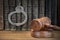 Handcuffs, Judge Gavel And Old Law Books On Wooden Table