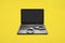 Handcuffs and laptop on yellow