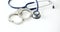 Handcuffs and medical stethoscope on white background closeup