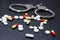 Handcuffs and pills and drugs on wooden table