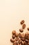 A handful of arabica coffee beans on a brown background. Vertical photo with place for text for roasters.