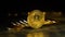 Handful of bitcoins stacked on top of each other on a table one stands on an edge of a black gold background bokeh