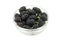 A handful of black mulberry berries in a glass bowl