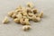 Handful of cashew nuts on a burlap fabric with selective focus.