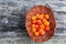 Handful of Cloudberry in wooden basket on an old wooden board background. Healthy diet