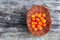 Handful of Cloudberry in wooden basket on an old wooden board background. Healthy diet
