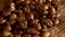 Handful of coffee beans on burlap sacking