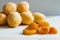 A handful of dried apricots on a background of fresh apricots